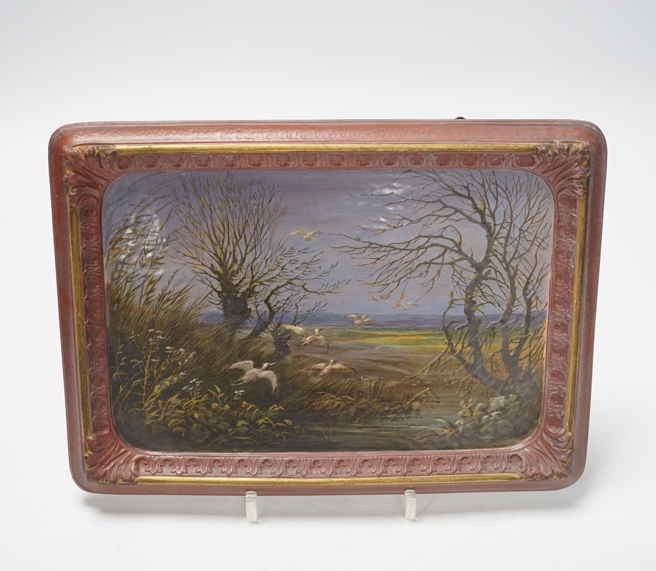 A late 19th century French painted faience plaque of storks in a landscape, 18 x 25cm